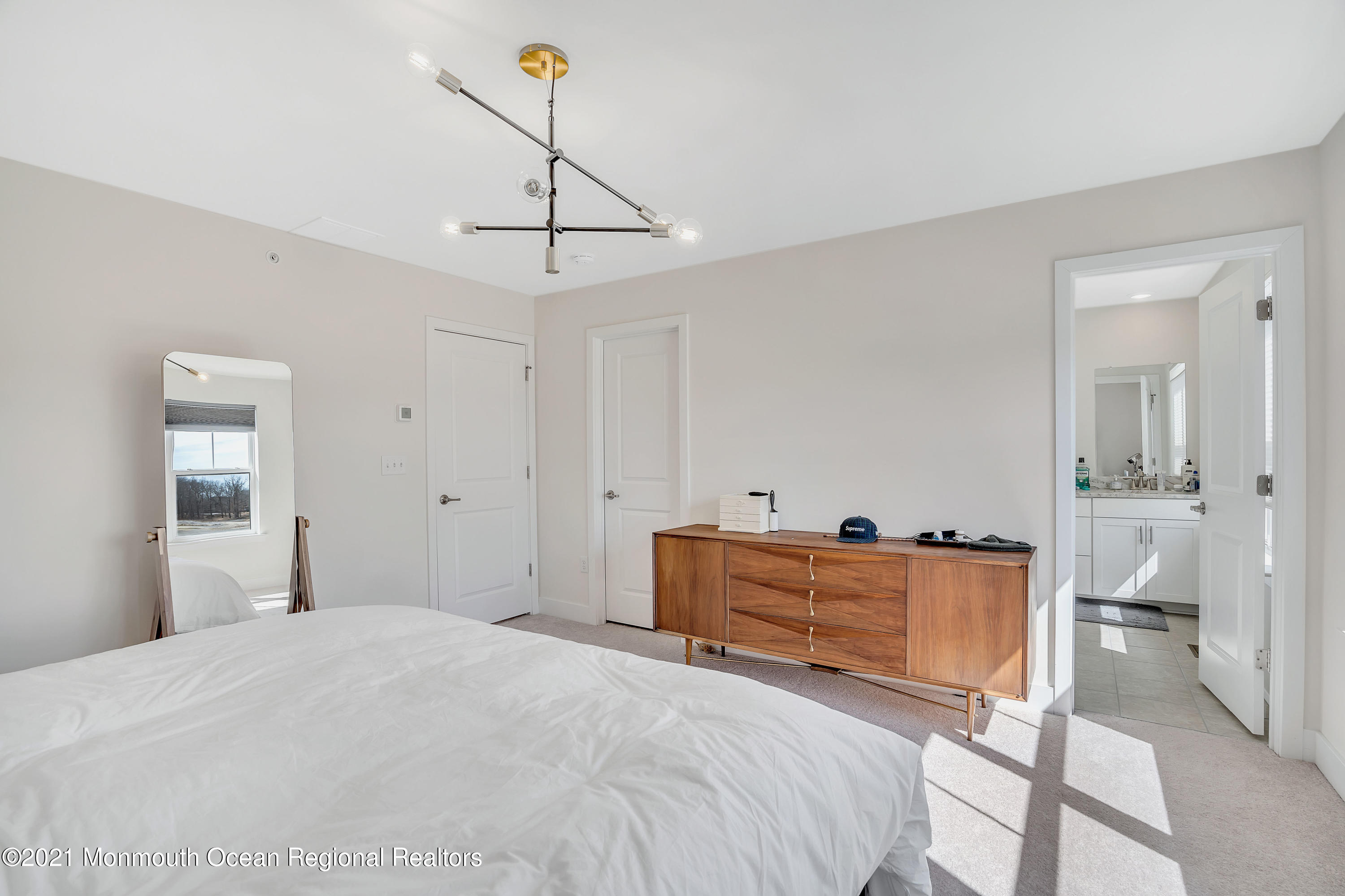 26 Kelly Way Tinton Falls, NJ 07724 - Photo 29 of 34 a bedroom with a bed and cabinets