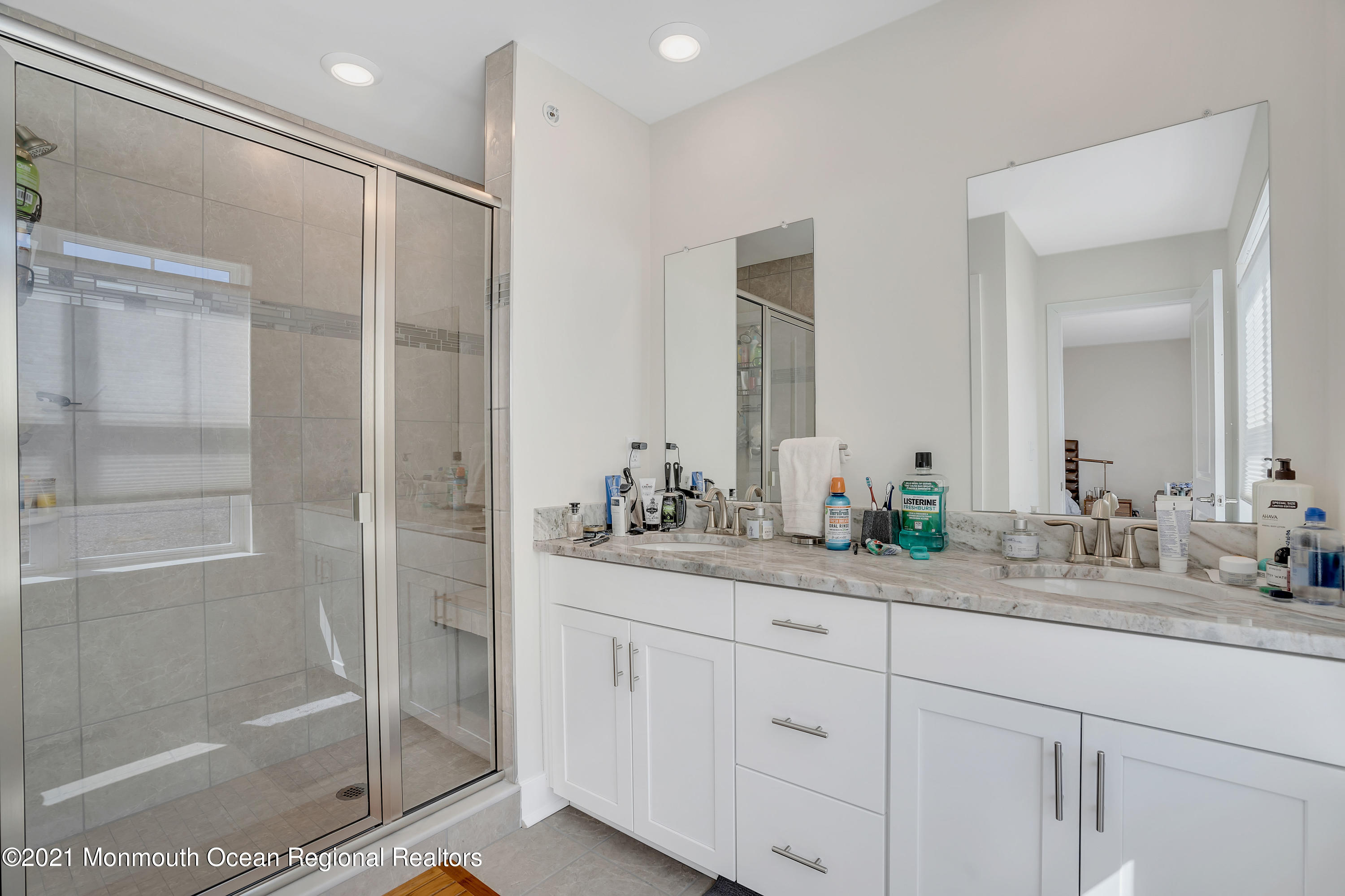 26 Kelly Way Tinton Falls, NJ 07724 - Photo 30 of 34 a bathroom with a shower sink and mirror