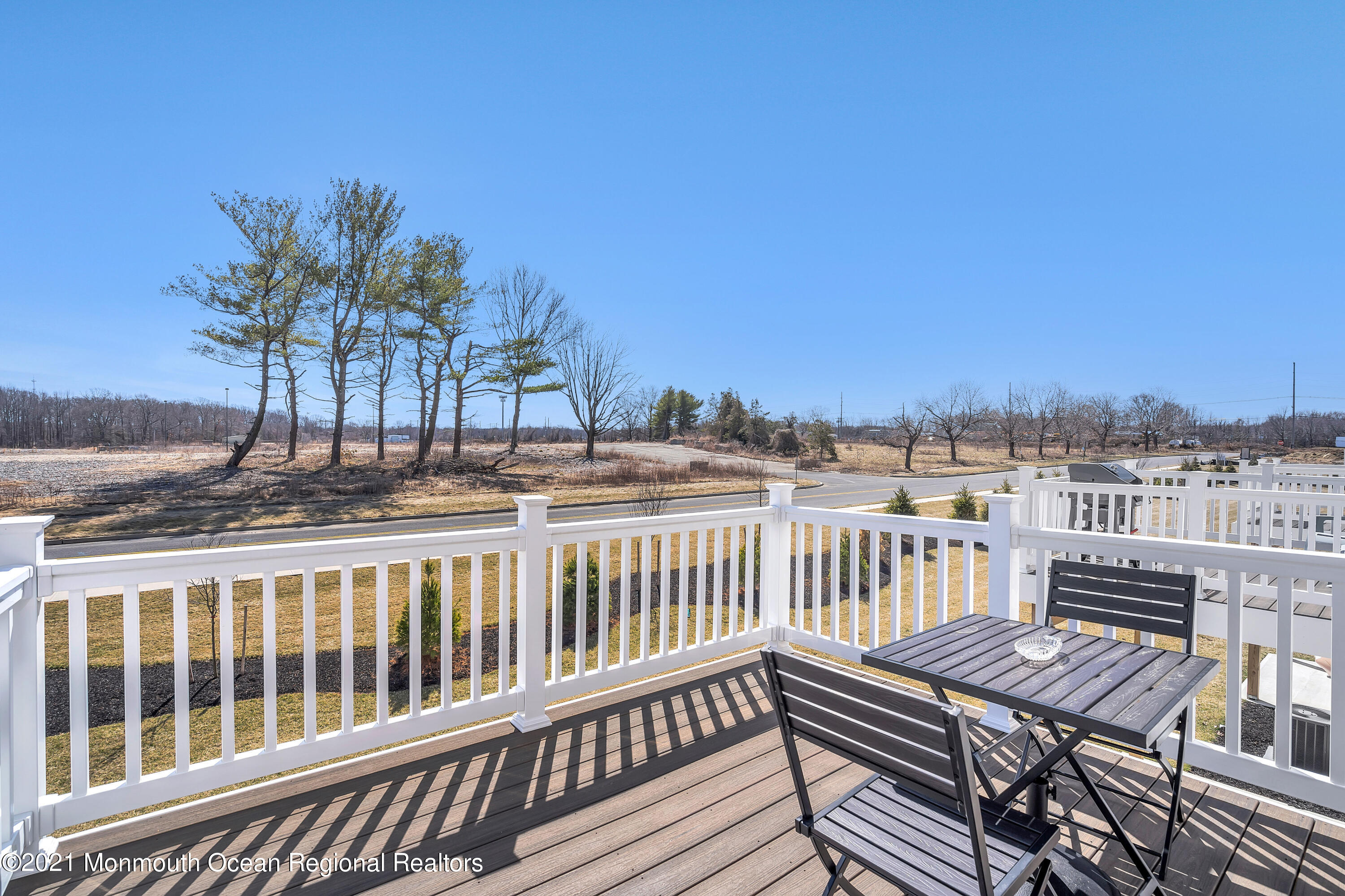26 Kelly Way Tinton Falls, NJ 07724 - Photo 32 of 34 a view of a balcony with wooden chairs and floor