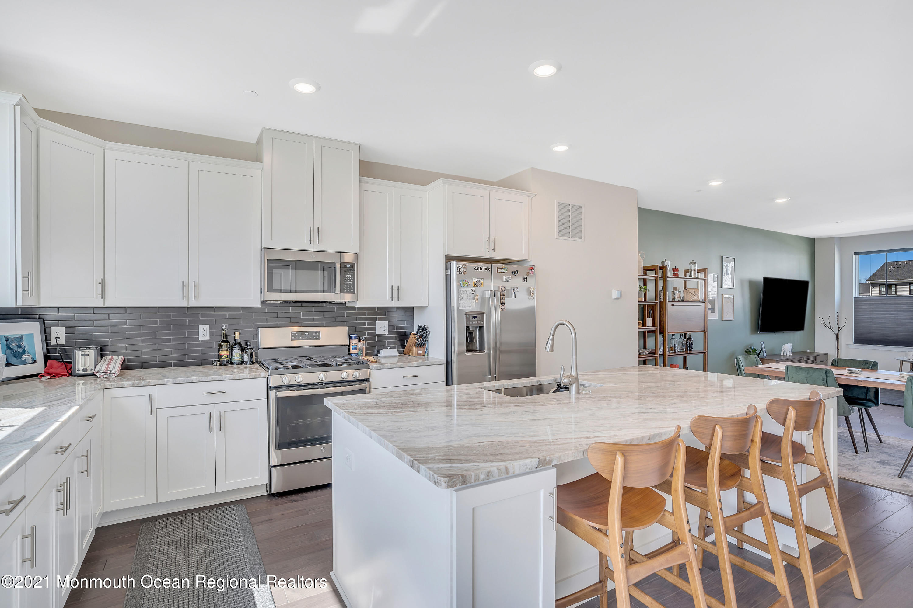 26 Kelly Way Tinton Falls, NJ 07724 - Photo 9 of 34 a kitchen with stainless steel appliances kitchen island granite countertop a sink and cabinets