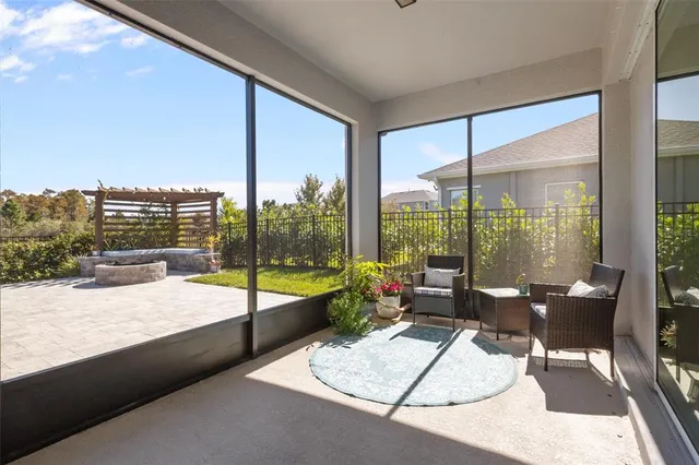 a bedroom with a balcony a bed and a chandelier