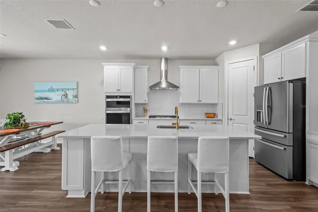 a living room with furniture a flat screen tv and a floor to ceiling window