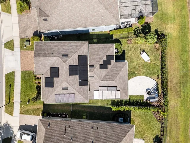 a kitchen with stainless steel appliances granite countertop a sink dishwasher and a dining table with wooden floor