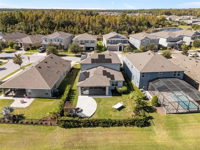 an aerial view of a house with swimming pool outdoor seating and yard