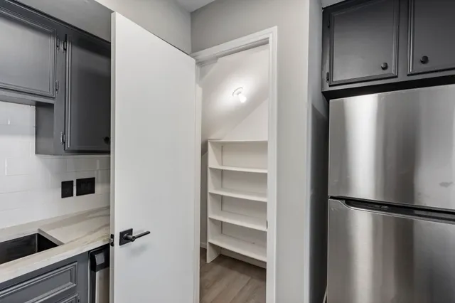 a view of a kitchen with a refrigerator and cabinets