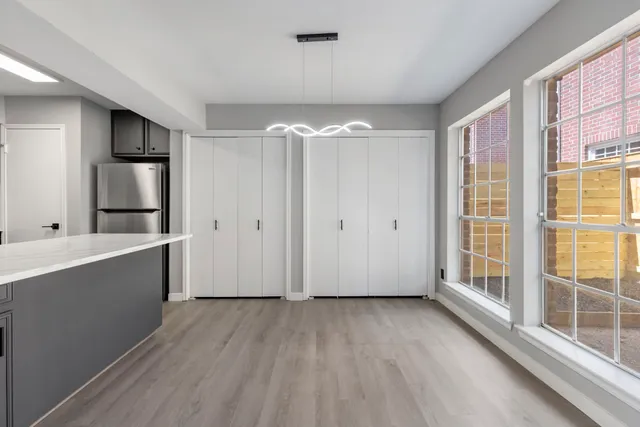 a view of a room with wooden floor and windows