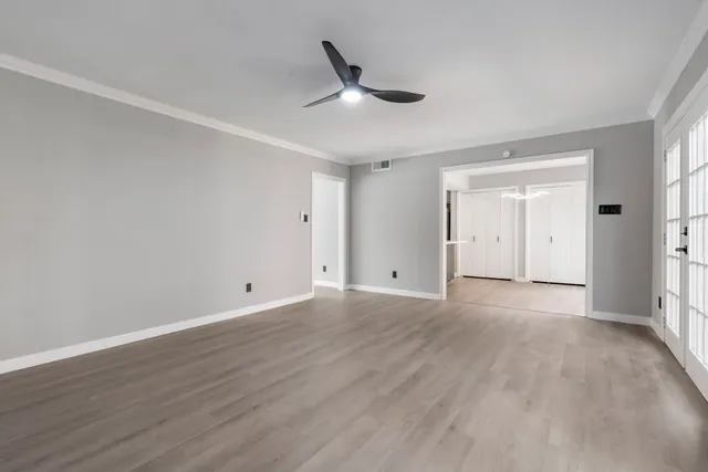 a view of an empty room and wooden floor