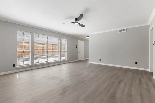 wooden floor in an empty room with a window