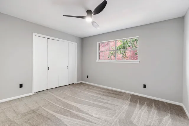 a view of room with window and ceiling fan