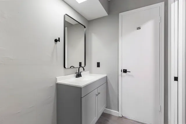 a bathroom with a sink and mirror