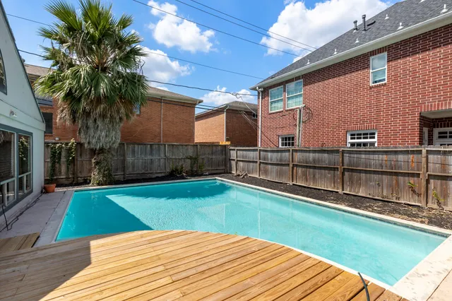a view of a backyard with wooden fence