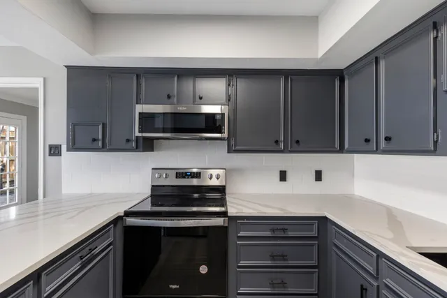 a kitchen with stainless steel appliances a stove and a sink