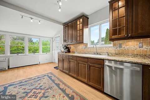 a kitchen with a sink window and cabinets