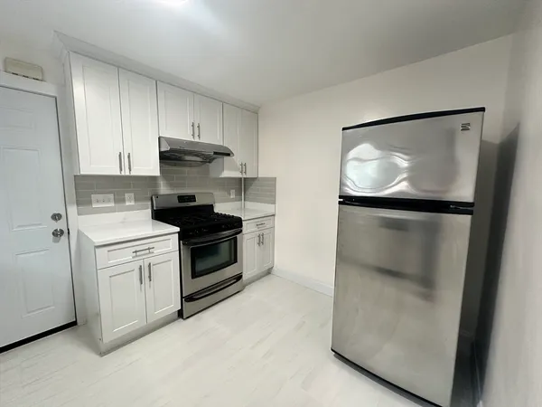 a kitchen with a stove and a refrigerator