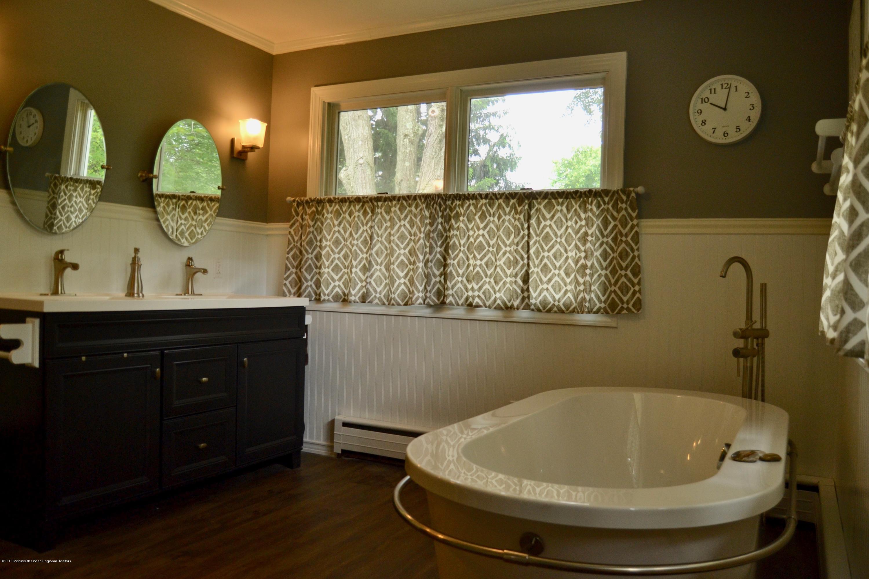 591 Craig Road Manalapan, NJ 07726 - Photo 8 of 17 a bathroom with a sink and a mirror