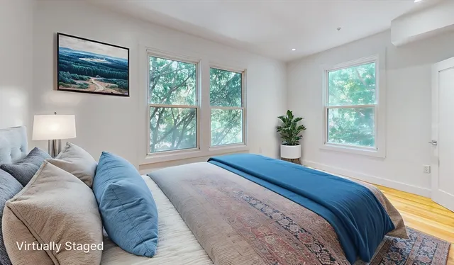 a bed sitting in a bedroom next to a window