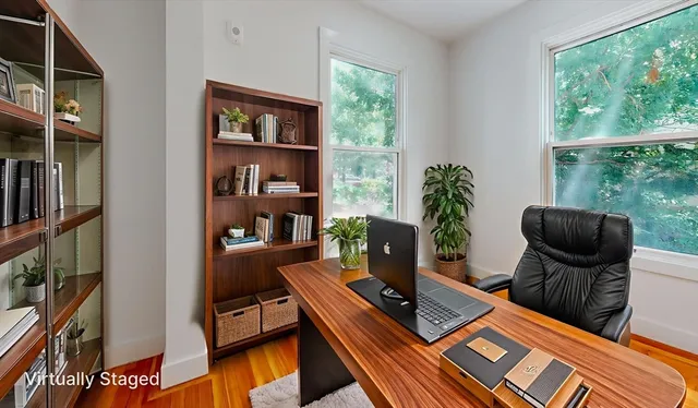 a living room with furniture fireplace and a window