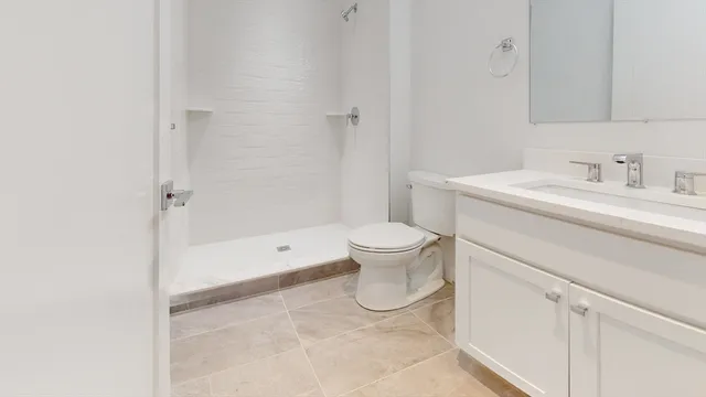 a spacious bathroom with a sink toilet and shower