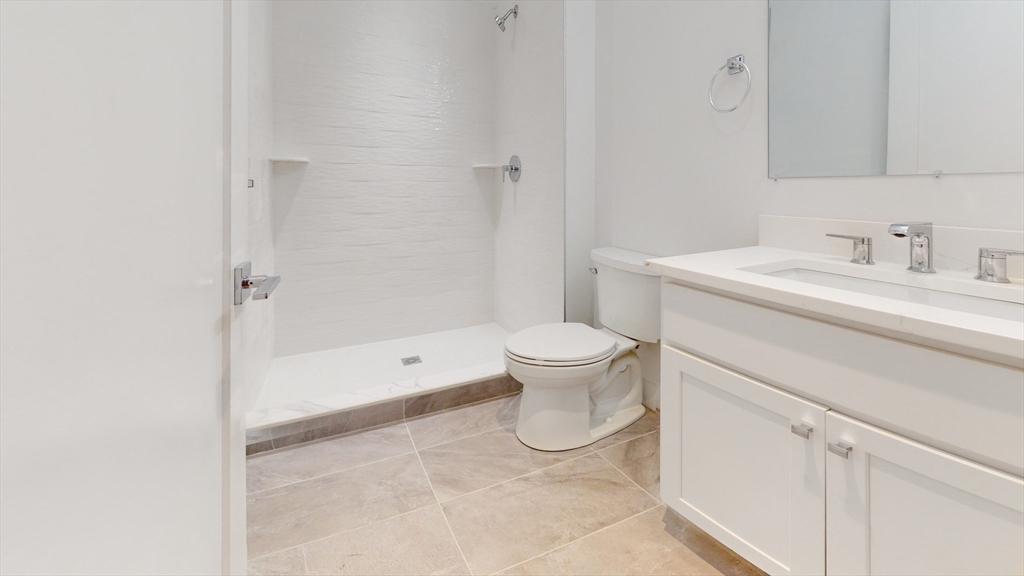 21 Regent Circle, Unit 3 Brookline, MA 02445 - Photo 8 of 11 a spacious bathroom with a sink toilet and shower