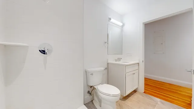 a bathroom with a sink a toilet and shower