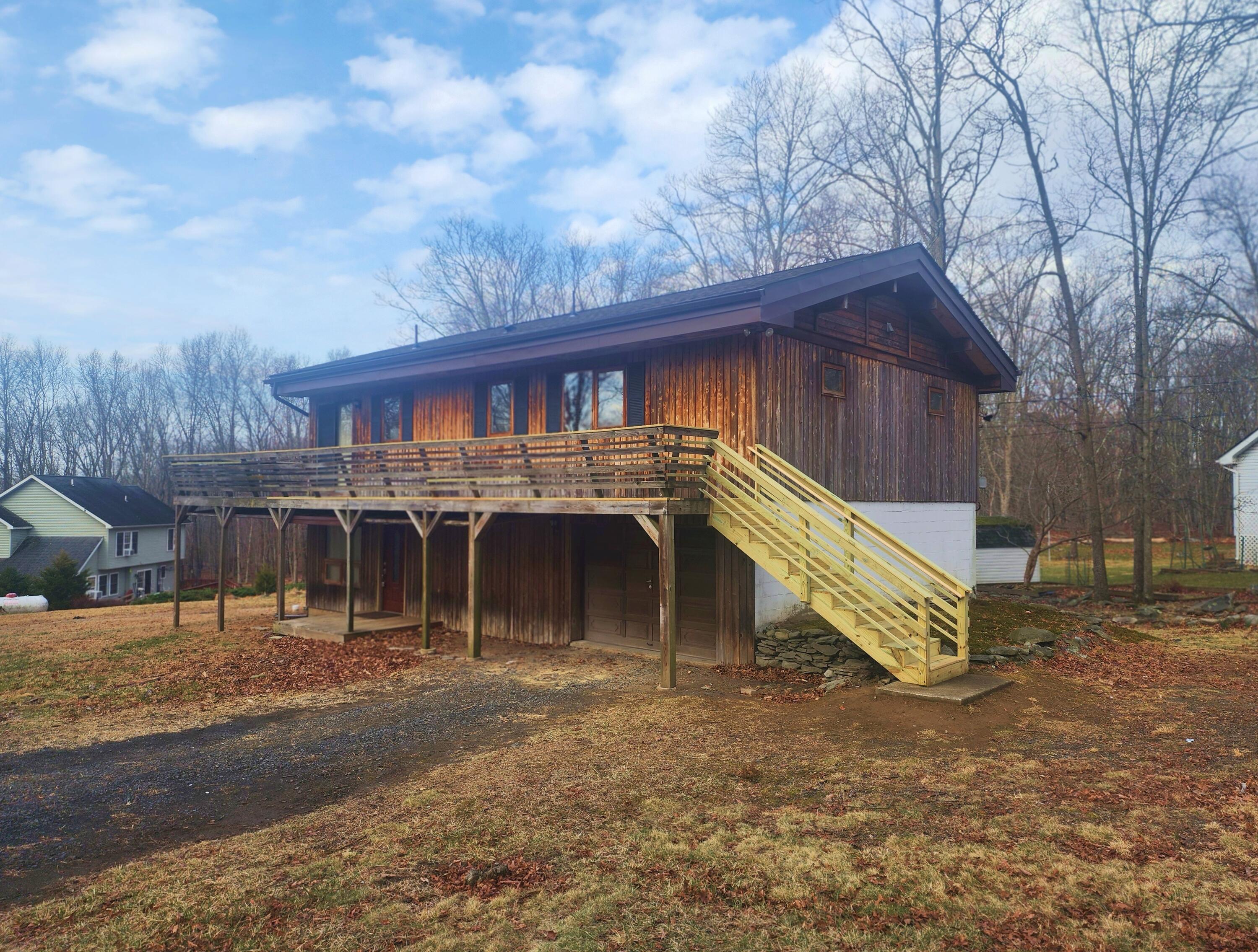 a view of a house with a yard and garage