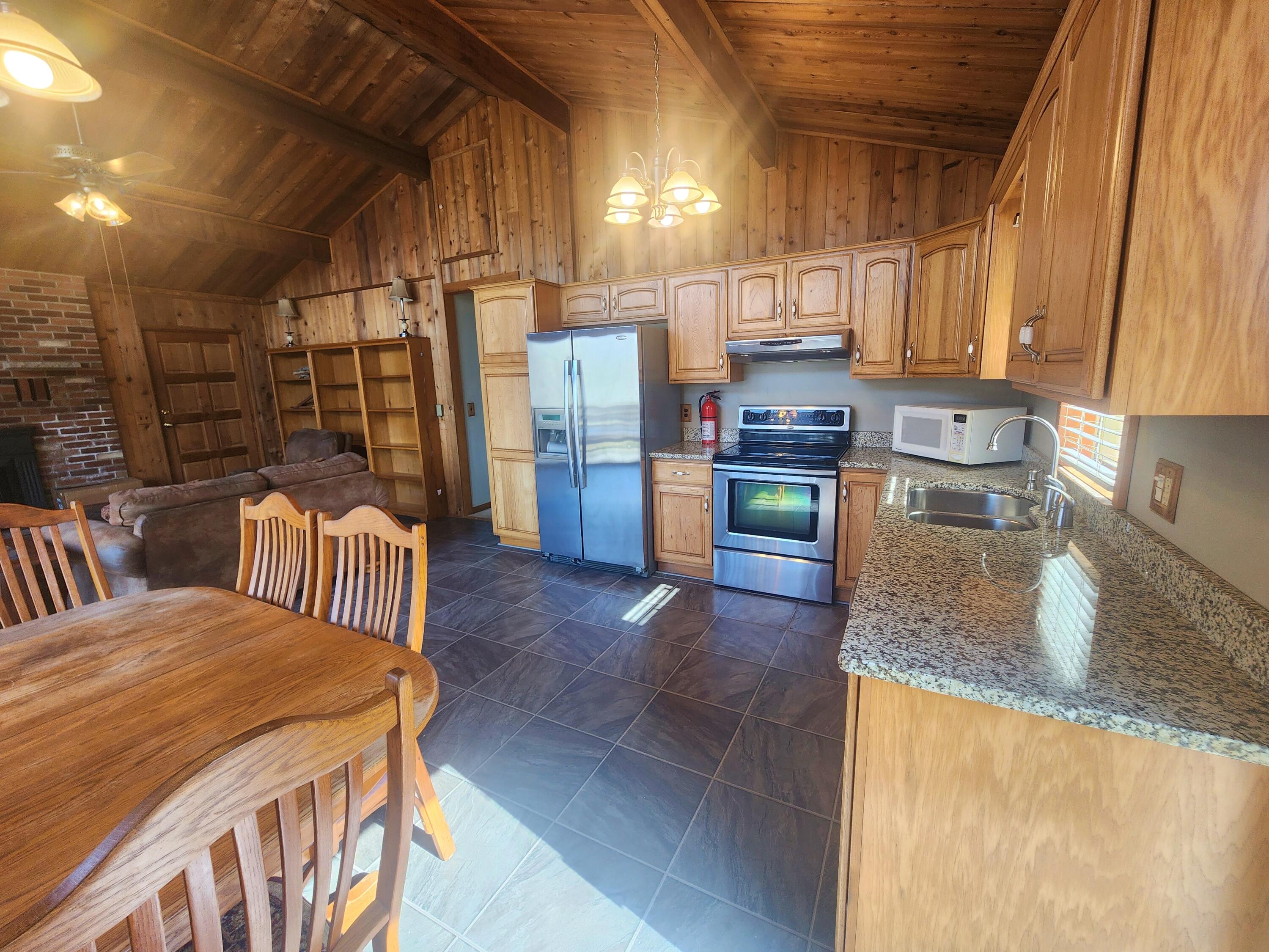2263 Cramer Road Bushkill, PA 18324 - Photo 11 of 70 a kitchen with lots of counter top space wooden floor and appliances