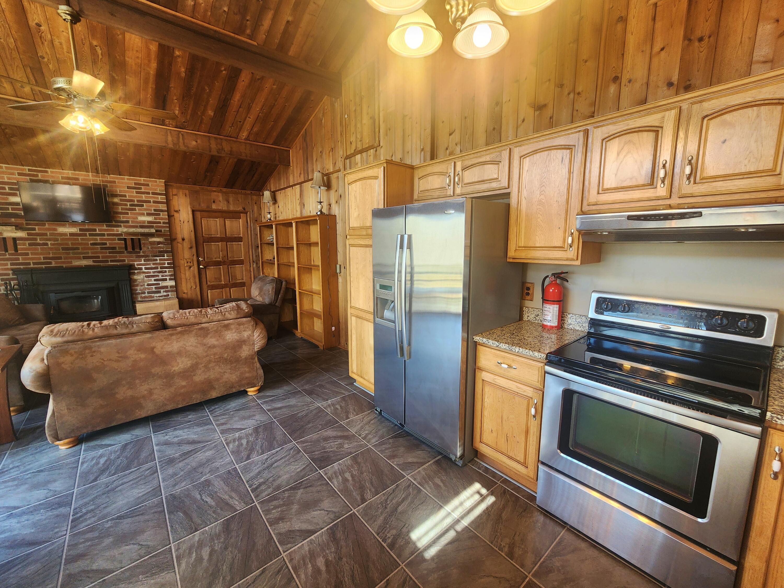 2263 Cramer Road Bushkill, PA 18324 - Photo 12 of 70 a kitchen with stainless steel appliances granite countertop a stove a refrigerator and a microwave