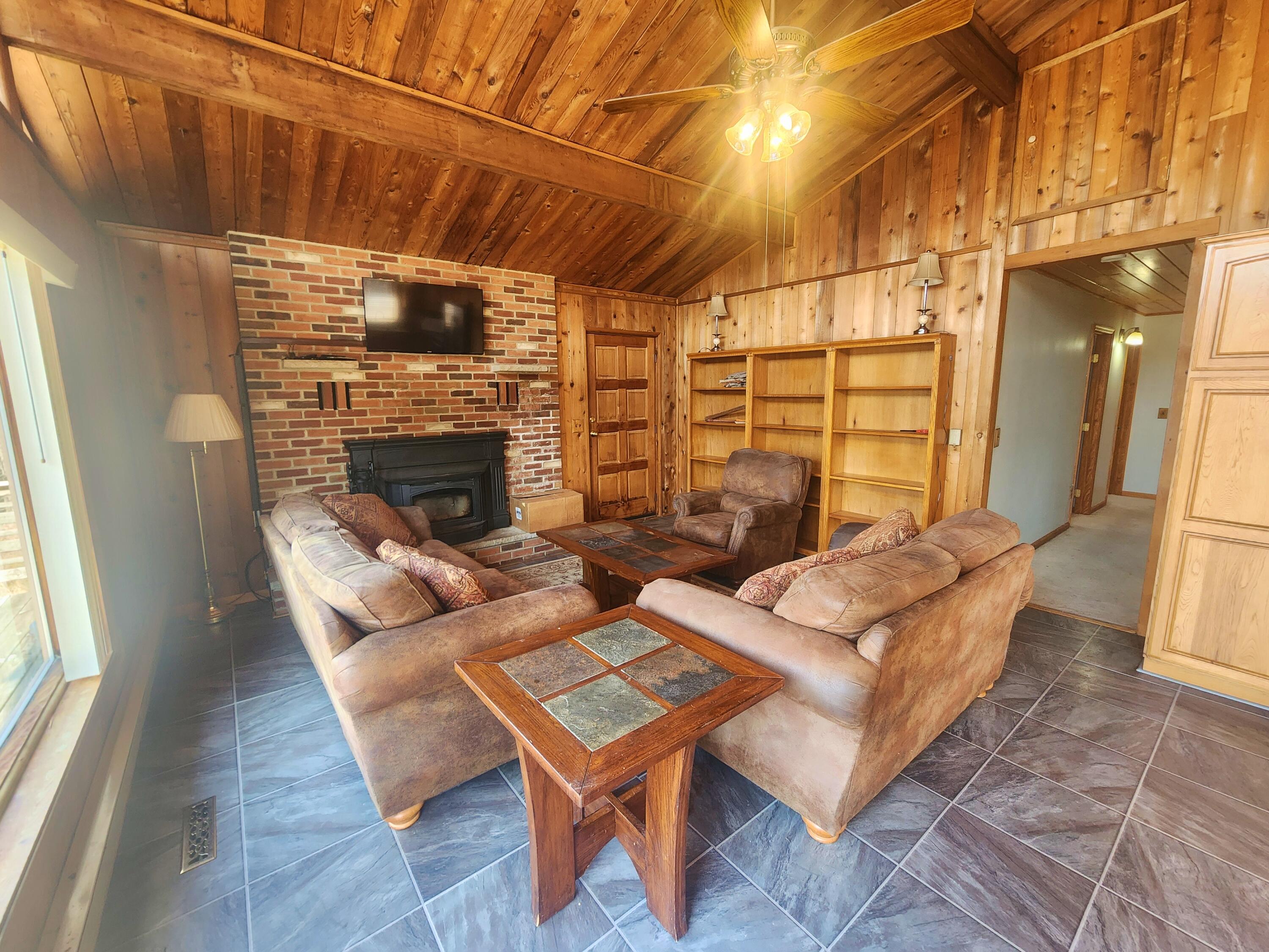 2263 Cramer Road Bushkill, PA 18324 - Photo 18 of 70 a living room with furniture a fireplace and a table