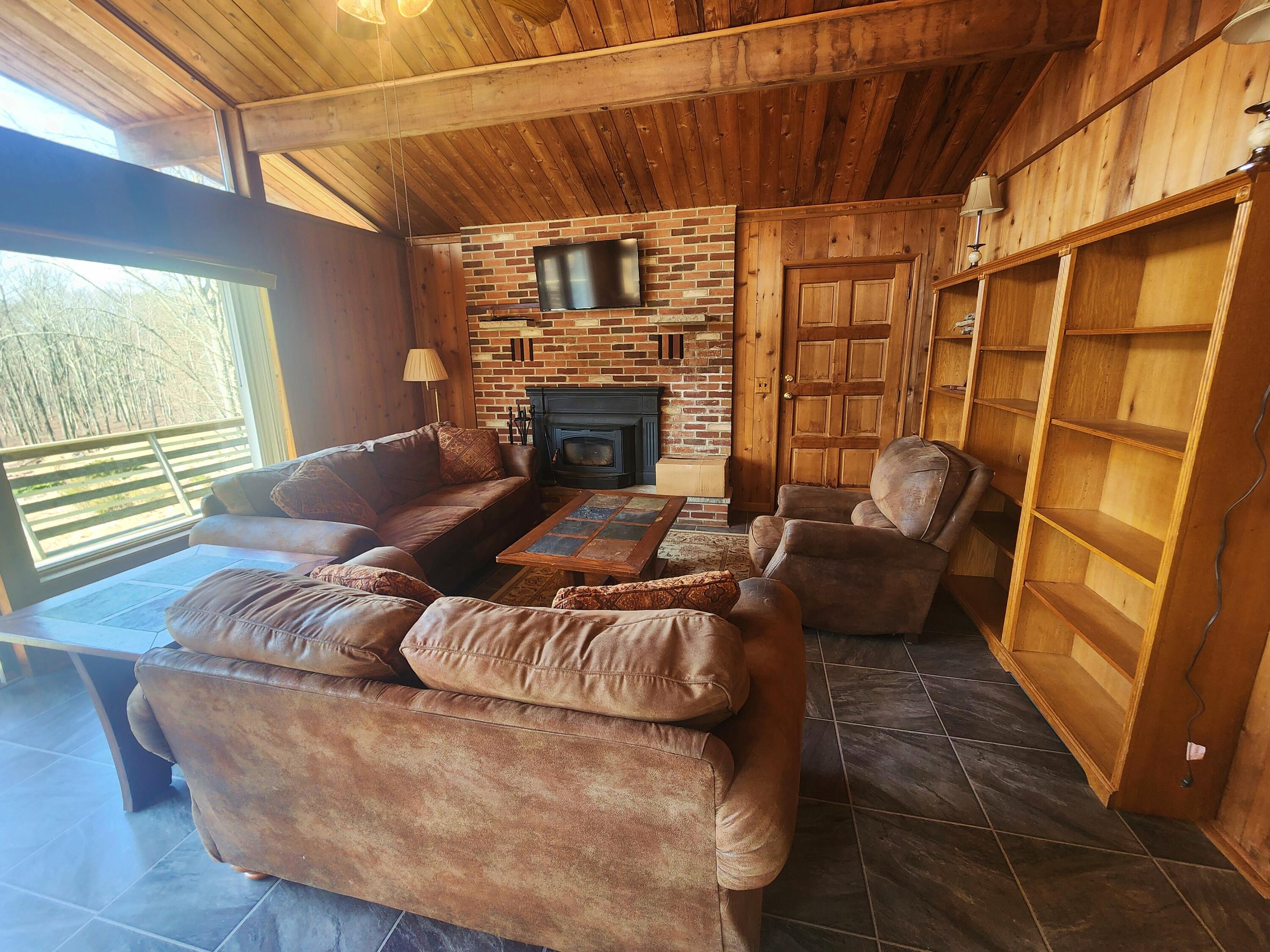 2263 Cramer Road Bushkill, PA 18324 - Photo 19 of 70 a living room with furniture and a fireplace