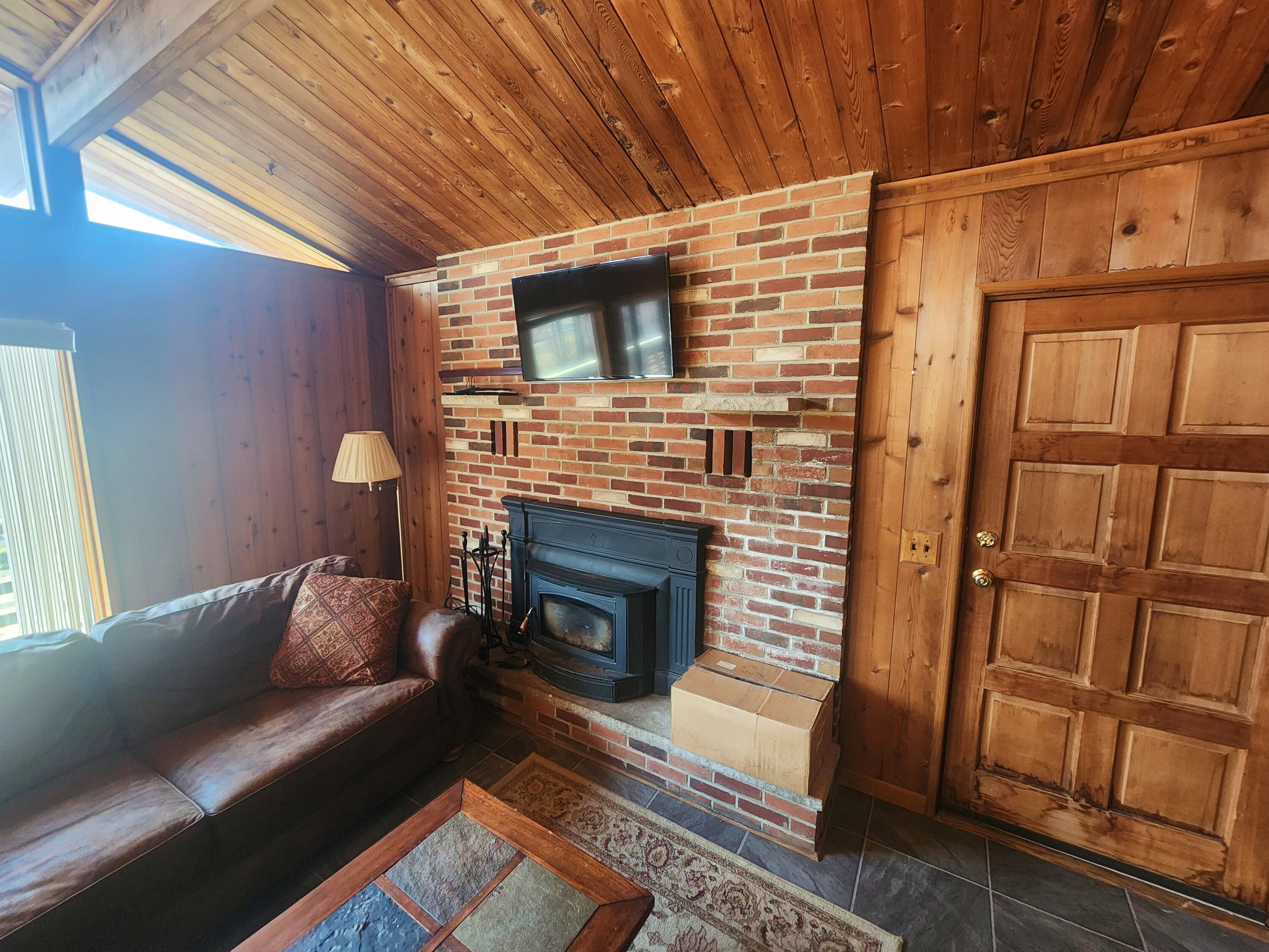 2263 Cramer Road Bushkill, PA 18324 - Photo 20 of 70 a living room with furniture and a fireplace