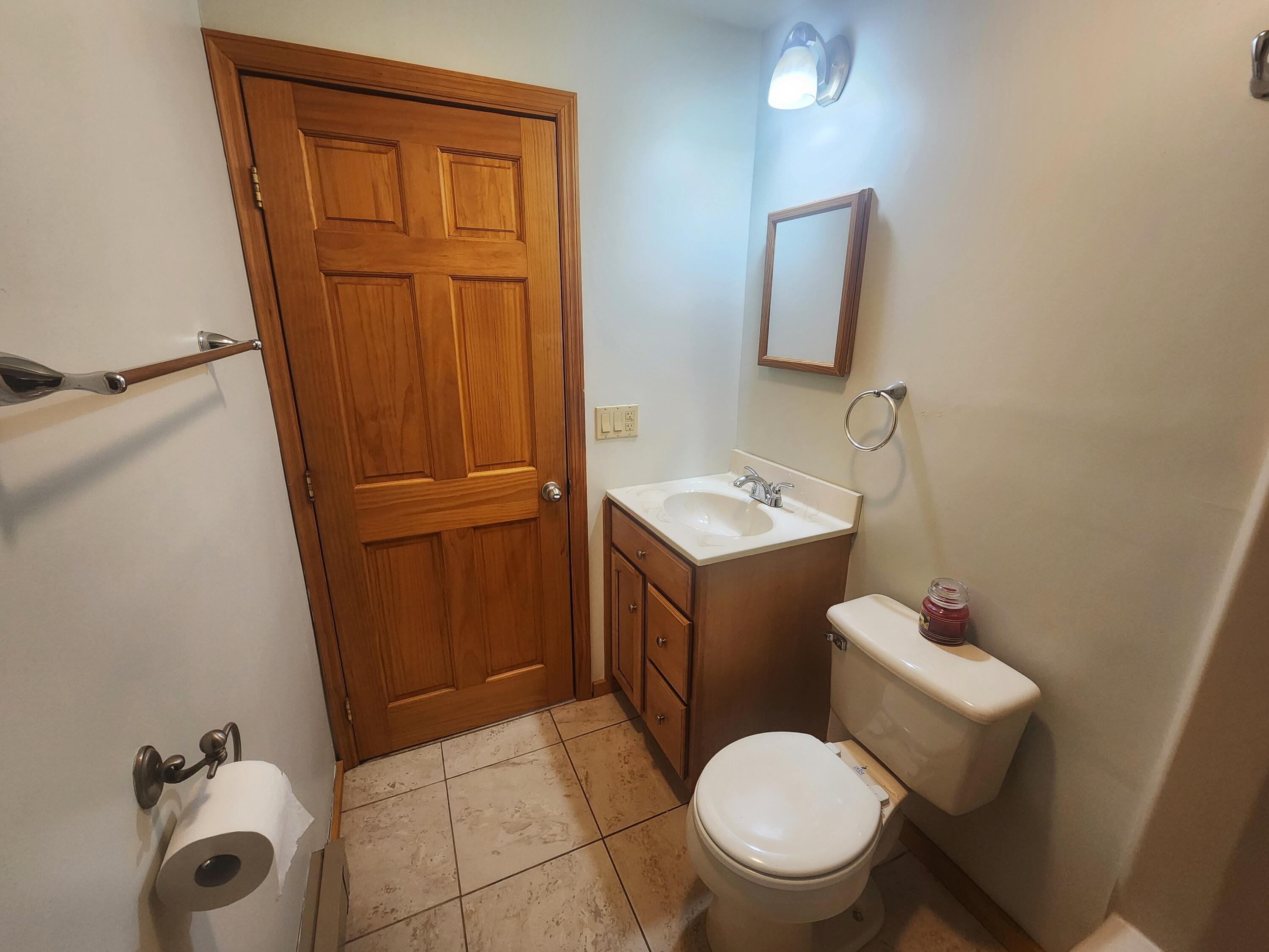 2263 Cramer Road Bushkill, PA 18324 - Photo 43 of 70 a white toilet sitting next to a bathroom sink and vanity