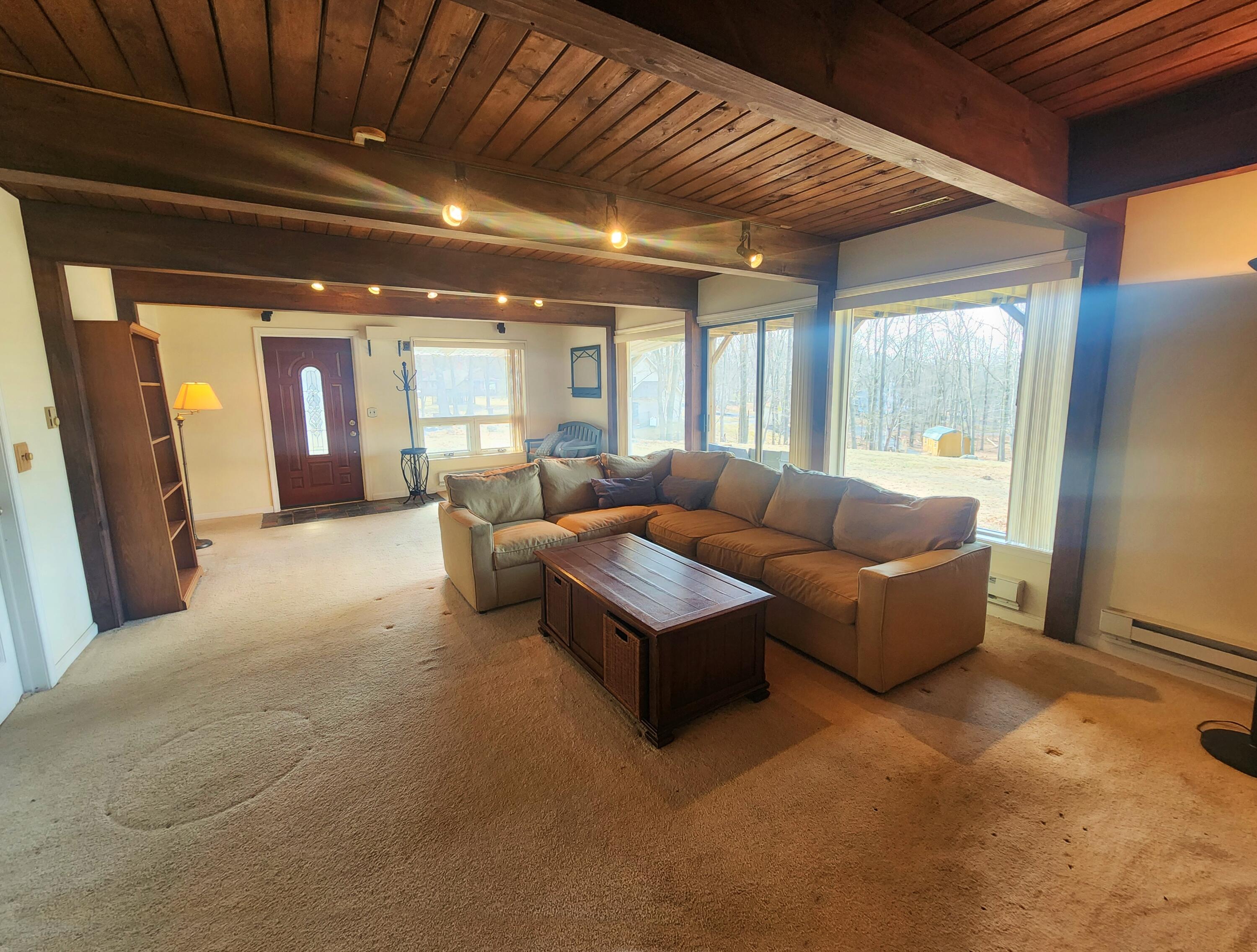 2263 Cramer Road Bushkill, PA 18324 - Photo 47 of 70 a living room with furniture and a chandelier