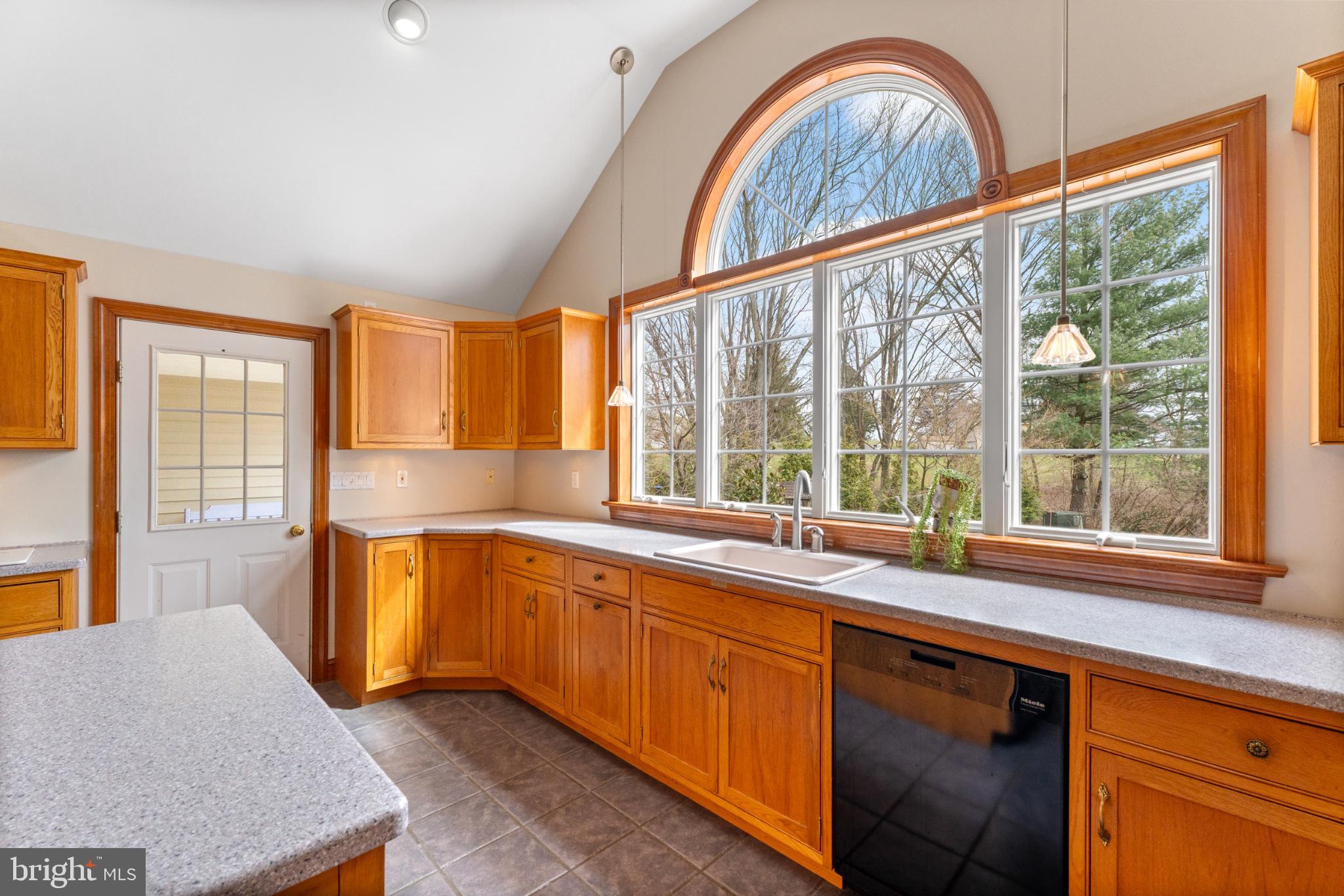 40 Christman Road Kutztown, PA 19530 - Photo 17 of 48 a open kitchen with stainless steel appliances granite countertop a stove a sink and a large window