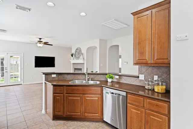 a spacious bathroom with a granite countertop sink and a mirror
