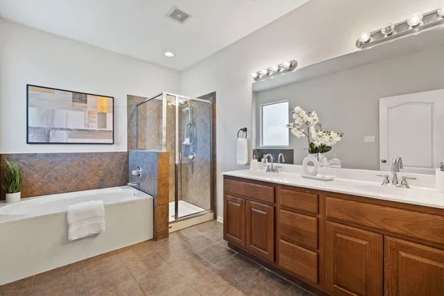 a bathroom with a tub sink and mirror