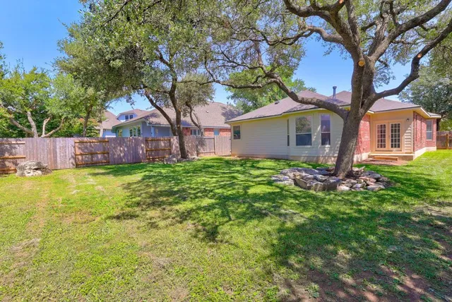a front view of house with yard and trees