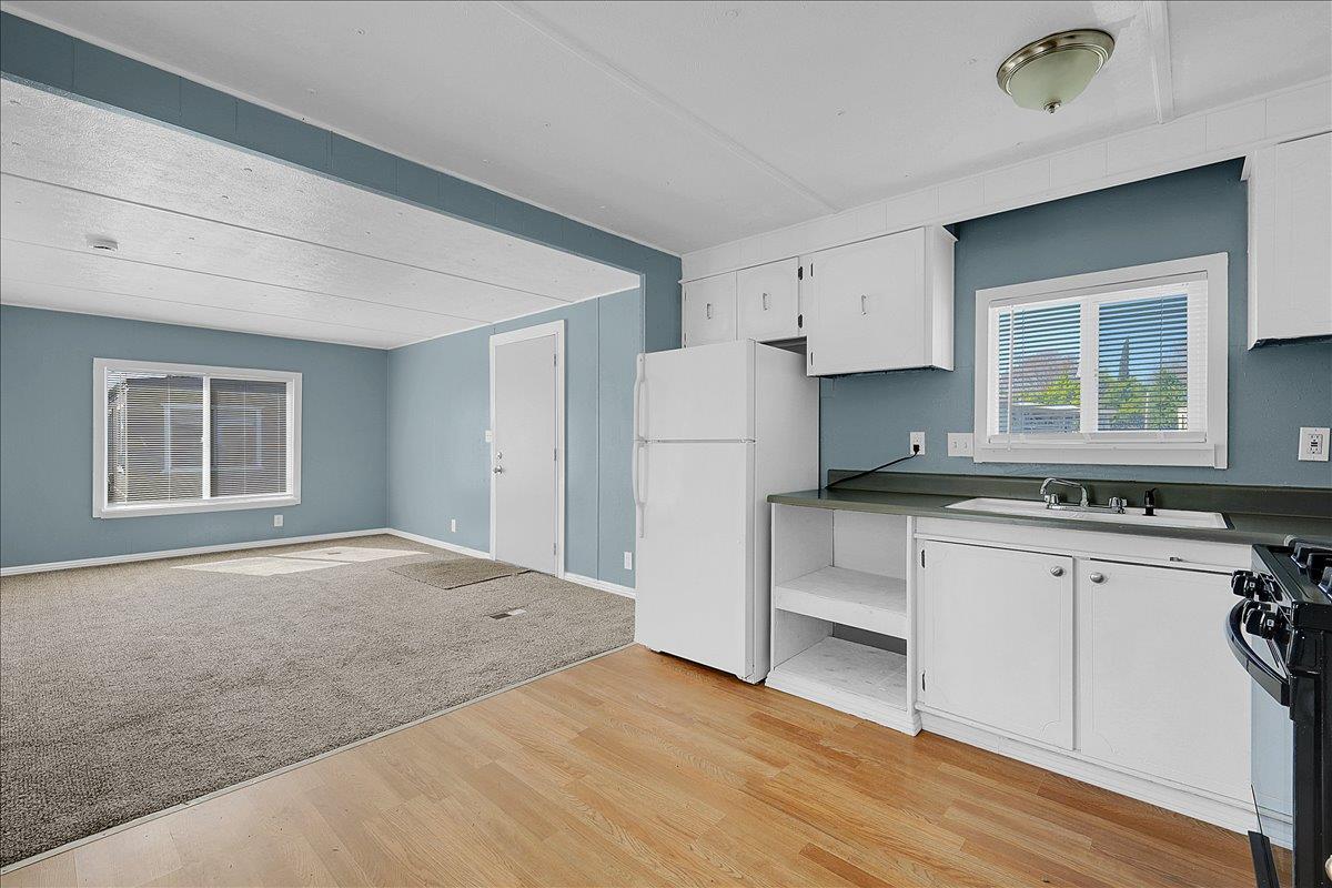 1523 North Beale Road, Unit 47 Marysville, CA 95901 - Photo 11 of 17 a kitchen with white cabinets and a refrigerator