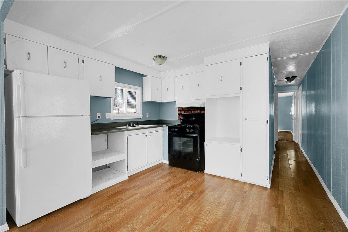 1523 North Beale Road, Unit 47 Marysville, CA 95901 - Photo 10 of 17 a kitchen with a refrigerator and a stove top oven