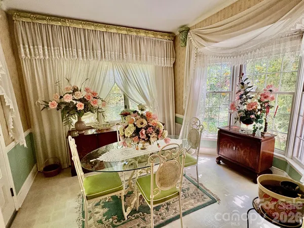 a view of a dining room with furniture and a potted plant
