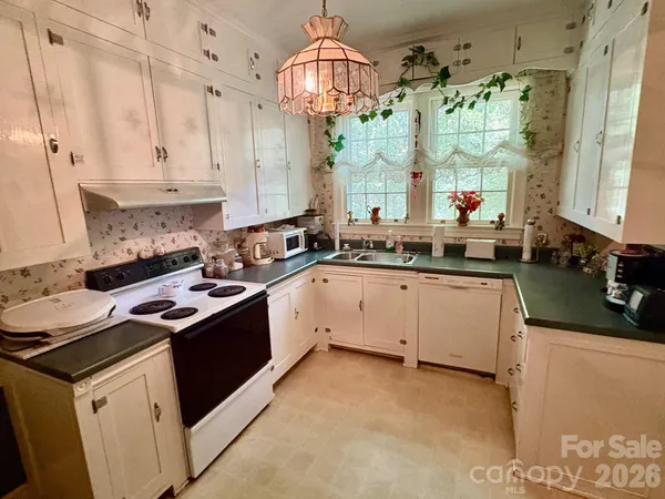 a kitchen that has a sink and a stove