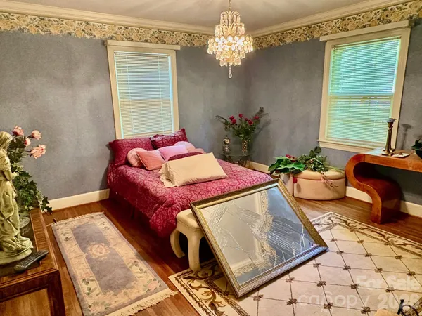 a living room with a bed and a chandelier