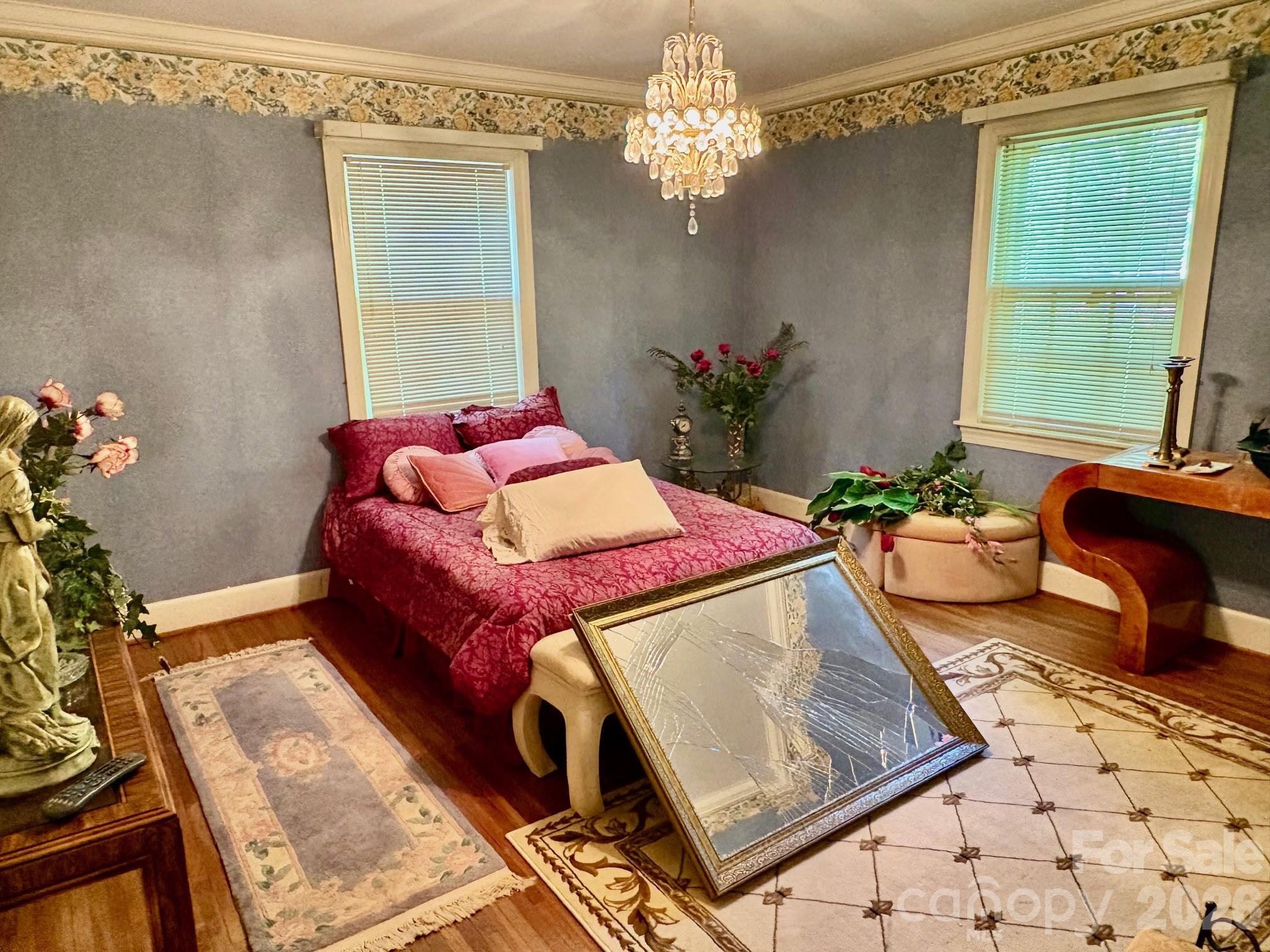 1612 South New Hope Road Gastonia, NC 28054 - Photo 21 of 38 a living room with a bed and a chandelier