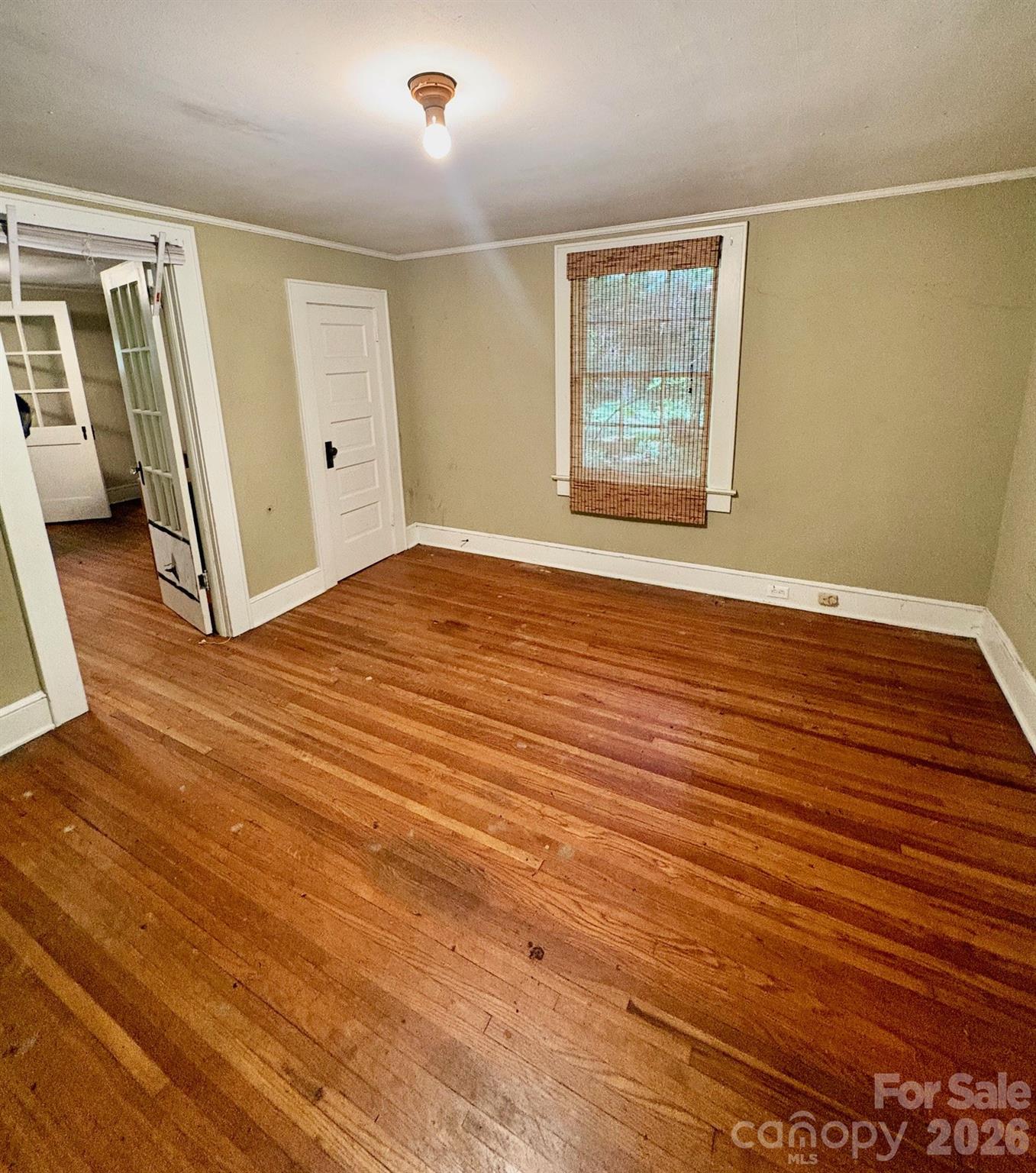 1612 South New Hope Road Gastonia, NC 28054 - Photo 30 of 38 a view of an empty room with wooden floor and a window