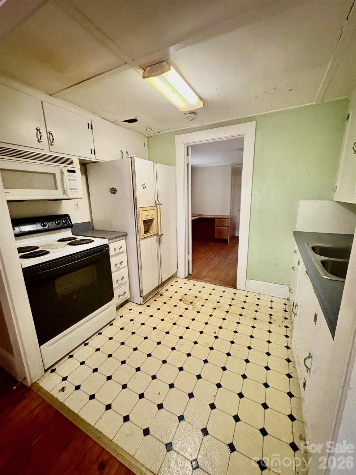 1612 South New Hope Road Gastonia, NC 28054 - Photo 32 of 38 a kitchen with a sink cabinets and stainless steel appliances