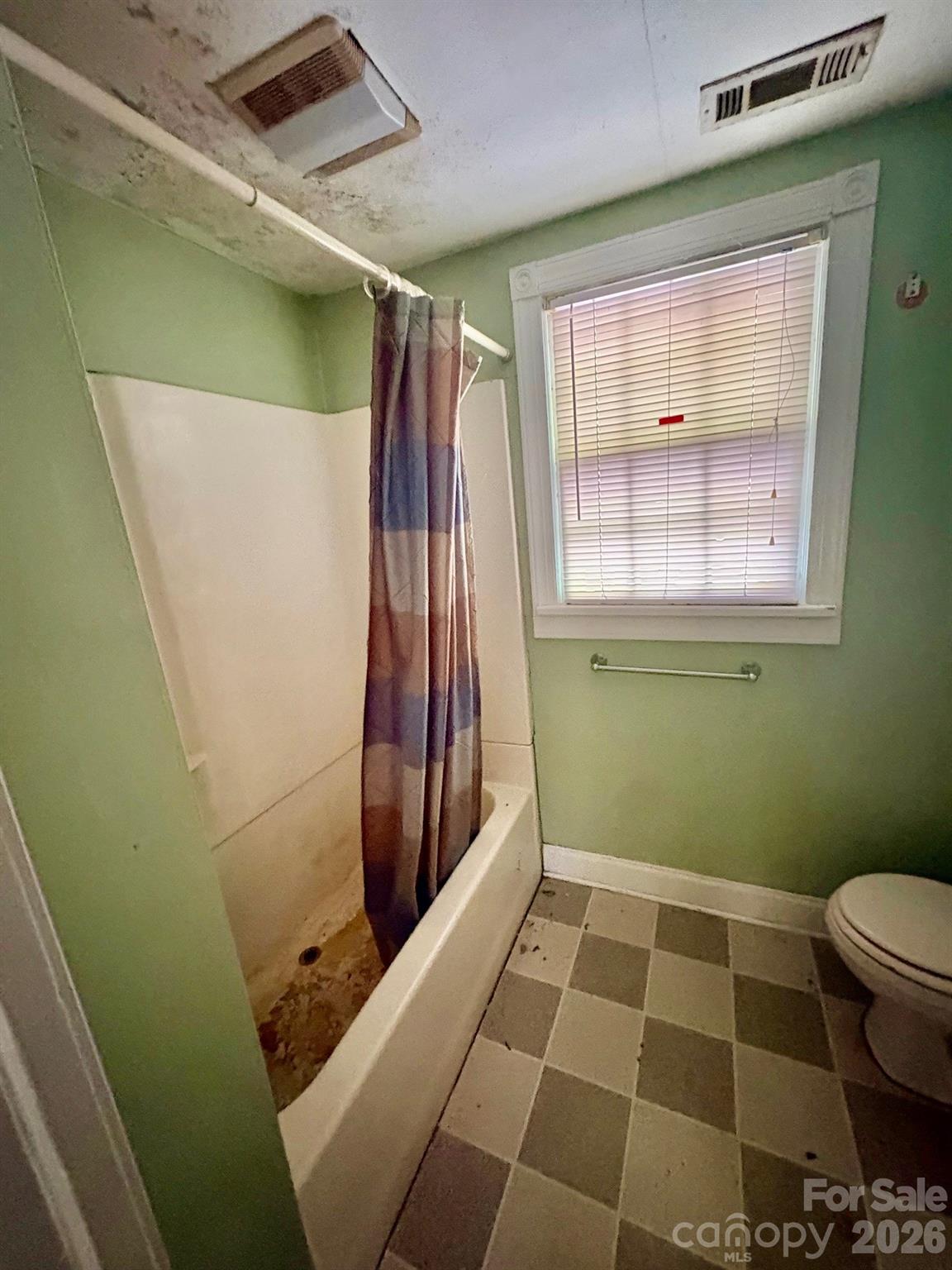 1612 South New Hope Road Gastonia, NC 28054 - Photo 35 of 38 a bathroom with a window and a toilet