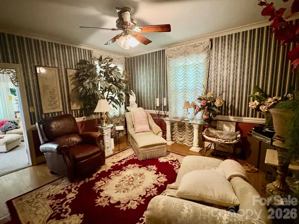 a bedroom with furniture and a large window