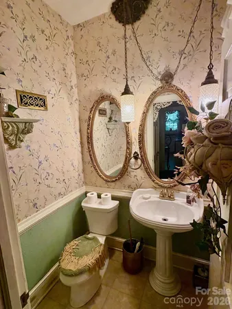 a bathroom with a toilet sink and mirror