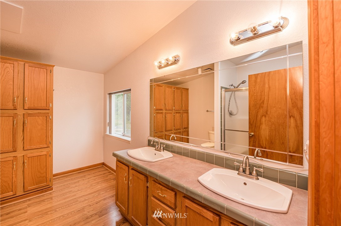 13 North Eldridge Road Sequim, WA 98382 - Photo 11 of 23 a bathroom with a granite countertop sink and a mirror