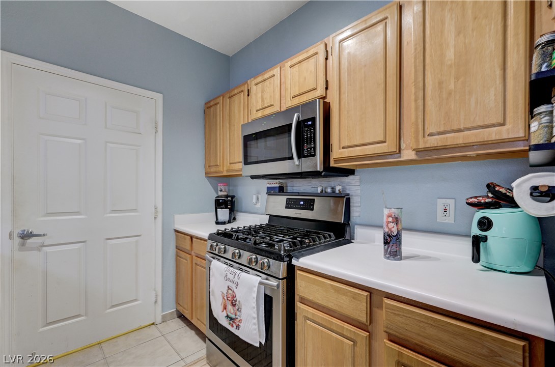 8555 West Russell Road, Unit 1017 Las Vegas, NV 89113 - Photo 8 of 34 A well-appointed kitchen features warm wood cabinetry, modern stainless steel appliances, and ample counter space.