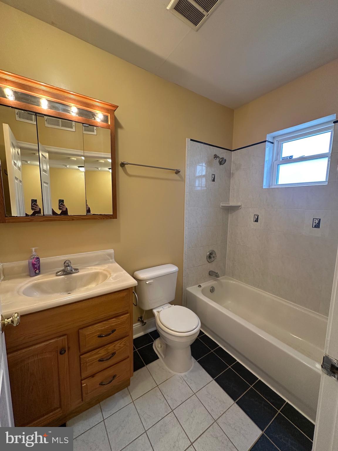 422 West Franklin Street, Unit 1B Baltimore, MD 21201 - Photo 15 of 17 a bathroom with a sink a toilet and shower